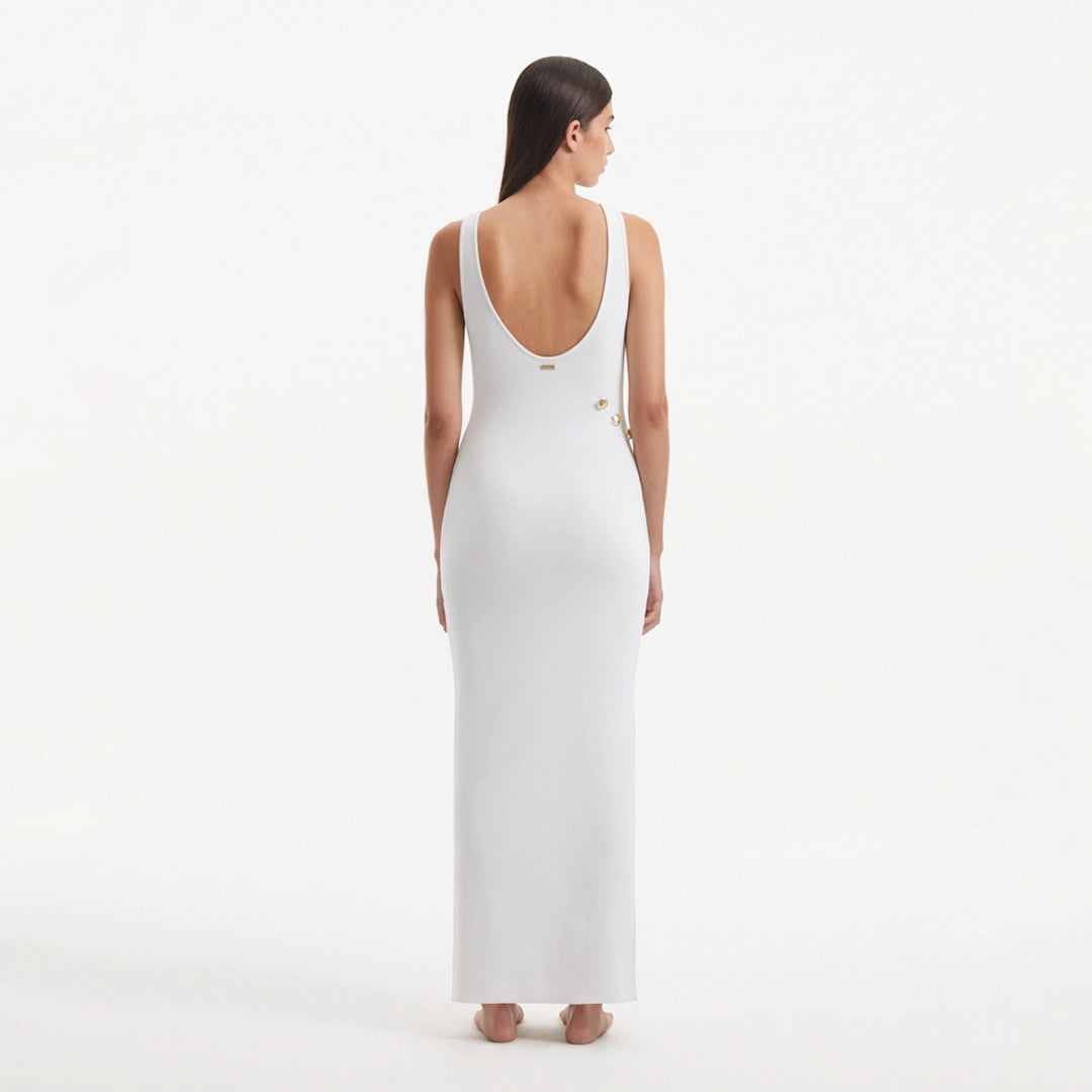 Raine White Knit Maxi Dress with Side Slit & Button Detail | Moeva | RTW Dresses | Each week unveils new pieces—luxury swimwear, fluid resort silhouettes, and elevated summer-to-evening essentials designed to carry you from coastal escapes to city nights.