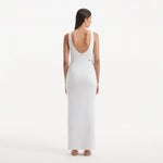 Raine White Knit Maxi Dress with Side Slit & Button Detail | Moeva | RTW Dresses | Each week unveils new pieces—luxury swimwear, fluid resort silhouettes, and elevated summer-to-evening essentials designed to carry you from coastal escapes to city nights.
