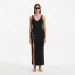 Raine Black Knit Maxi Dress with Side Slit & Button Detail | Moeva | RTW Dresses | Each week unveils new pieces—luxury swimwear, fluid resort silhouettes, and elevated summer-to-evening essentials designed to carry you from coastal escapes to city nights.