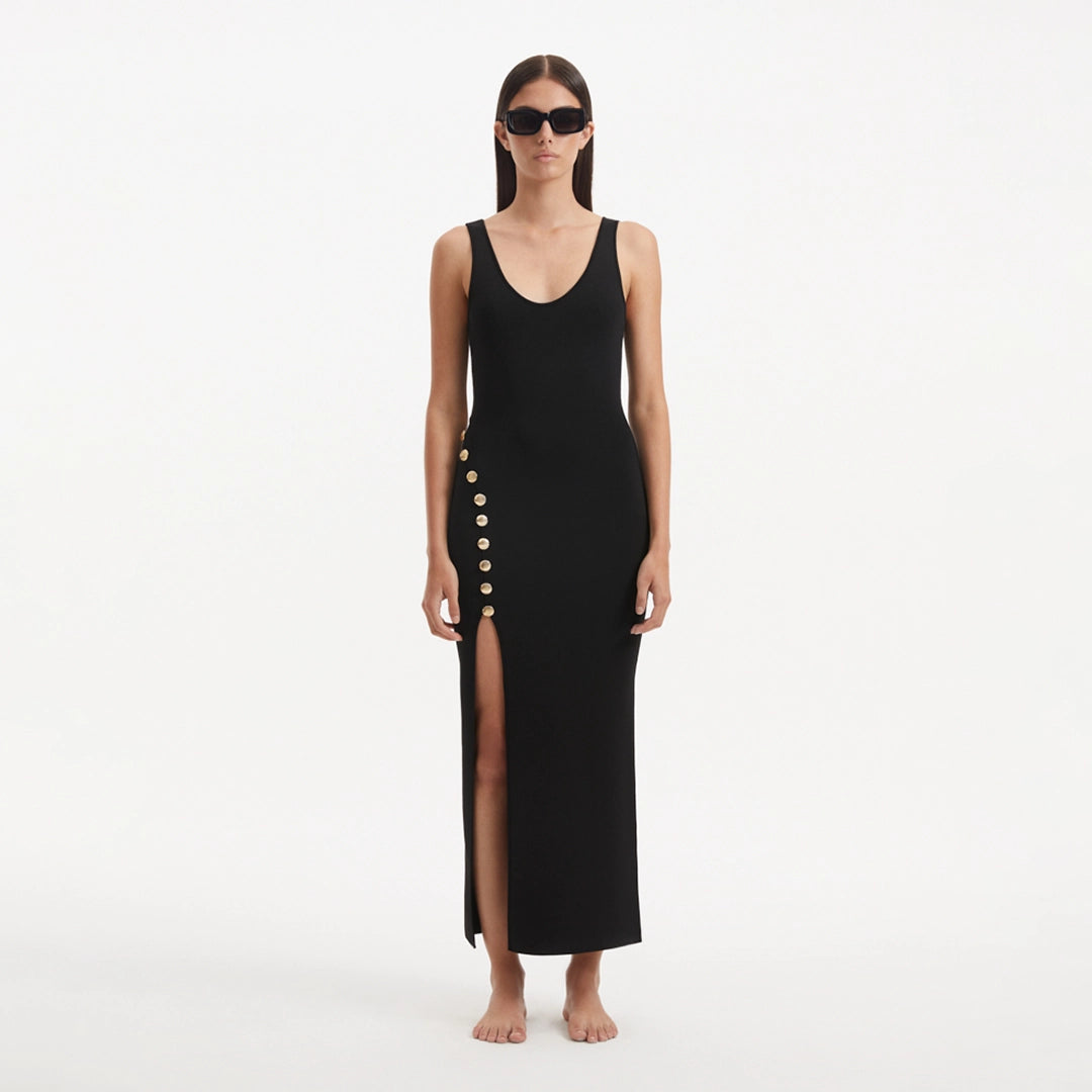 Raine Black Knit Maxi Dress with Side Slit & Button Detail | Moeva | RTW Dresses | Each week unveils new pieces—luxury swimwear, fluid resort silhouettes, and elevated summer-to-evening essentials designed to carry you from coastal escapes to city nights.