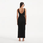 Raine Black Knit Maxi Dress with Side Slit & Button Detail | Moeva | RTW Dresses | Each week unveils new pieces—luxury swimwear, fluid resort silhouettes, and elevated summer-to-evening essentials designed to carry you from coastal escapes to city nights.