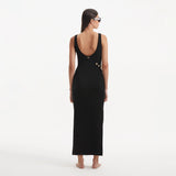 Raine Black Knit Maxi Dress with Side Slit & Button Detail | Moeva | RTW Dresses | Each week unveils new pieces—luxury swimwear, fluid resort silhouettes, and elevated summer-to-evening essentials designed to carry you from coastal escapes to city nights.