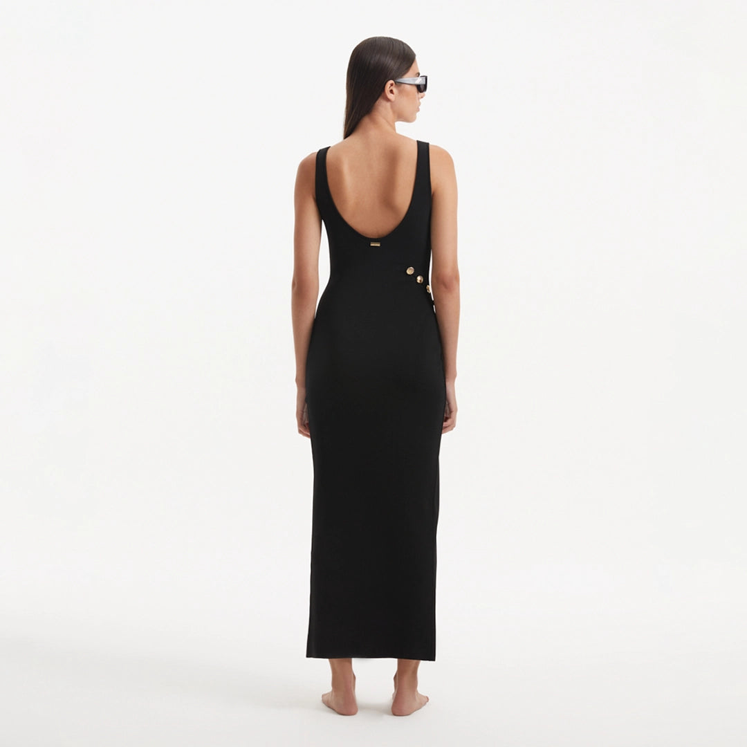 Raine Black Knit Maxi Dress with Side Slit & Button Detail | Moeva | RTW Dresses | Each week unveils new pieces—luxury swimwear, fluid resort silhouettes, and elevated summer-to-evening essentials designed to carry you from coastal escapes to city nights.