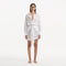 Nayeli White Tie-Front Cotton Shirt Dress | Moeva | Beachwear Dresses | Each week unveils new pieces—luxury swimwear, fluid resort silhouettes, and elevated summer-to-evening essentials designed to carry you from coastal escapes to city nights.