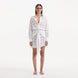 Nayeli White Tie-Front Cotton Shirt Dress | Moeva | Beachwear Dresses | Each week unveils new pieces—luxury swimwear, fluid resort silhouettes, and elevated summer-to-evening essentials designed to carry you from coastal escapes to city nights.