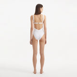 Breena White V Neck Swimsuit | Moeva | Swimsuit | Each week unveils new pieces—luxury swimwear, fluid resort silhouettes, and elevated summer-to-evening essentials designed to carry you from coastal escapes to city nights.