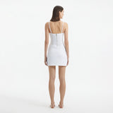 Osaka White Corset Mini Dress with Wrap Skirt | Moeva | RTW Dresses | Each week unveils new pieces—luxury swimwear, fluid resort silhouettes, and elevated summer-to-evening essentials designed to carry you from coastal escapes to city nights.