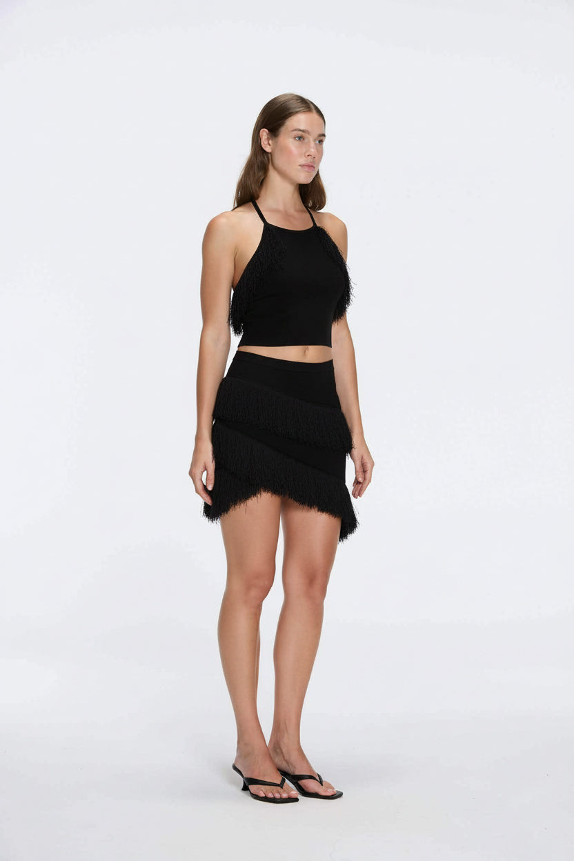 Arlo Black Fringe Detail Asymmetric Mini Skirt | Moeva | RTW Skirts | Each week unveils new pieces—luxury swimwear, fluid resort silhouettes, and elevated summer-to-evening essentials designed to carry you from coastal escapes to city nights.