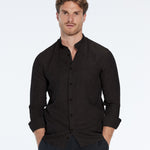 Man wearing a black shirt and pants on a white background
