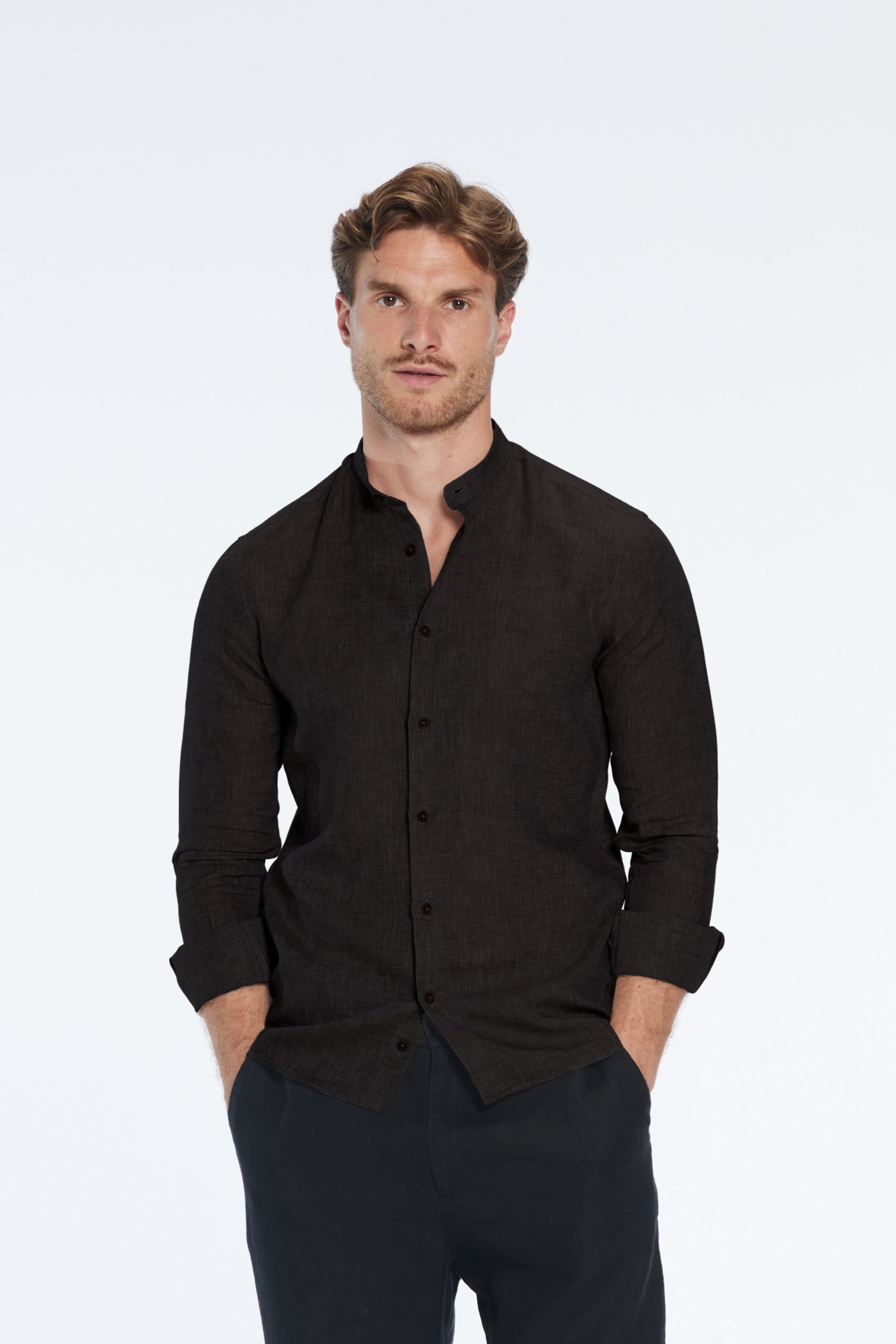 Man wearing a black shirt and pants on a white background