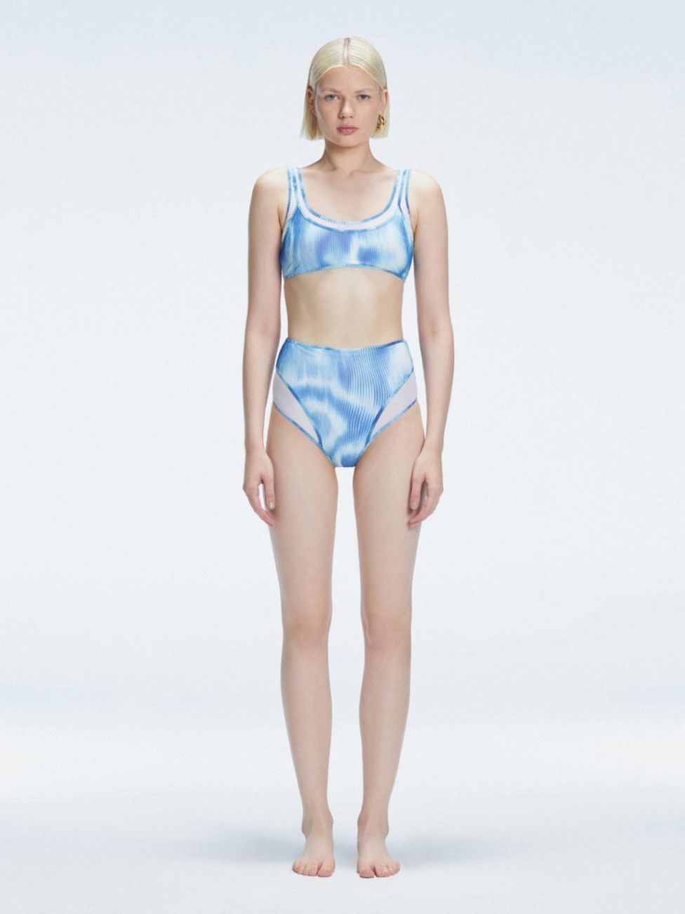 Front view of model wearing Rosalind Blue Optical Bikini Set with high-waisted design and two-layered tulle.
