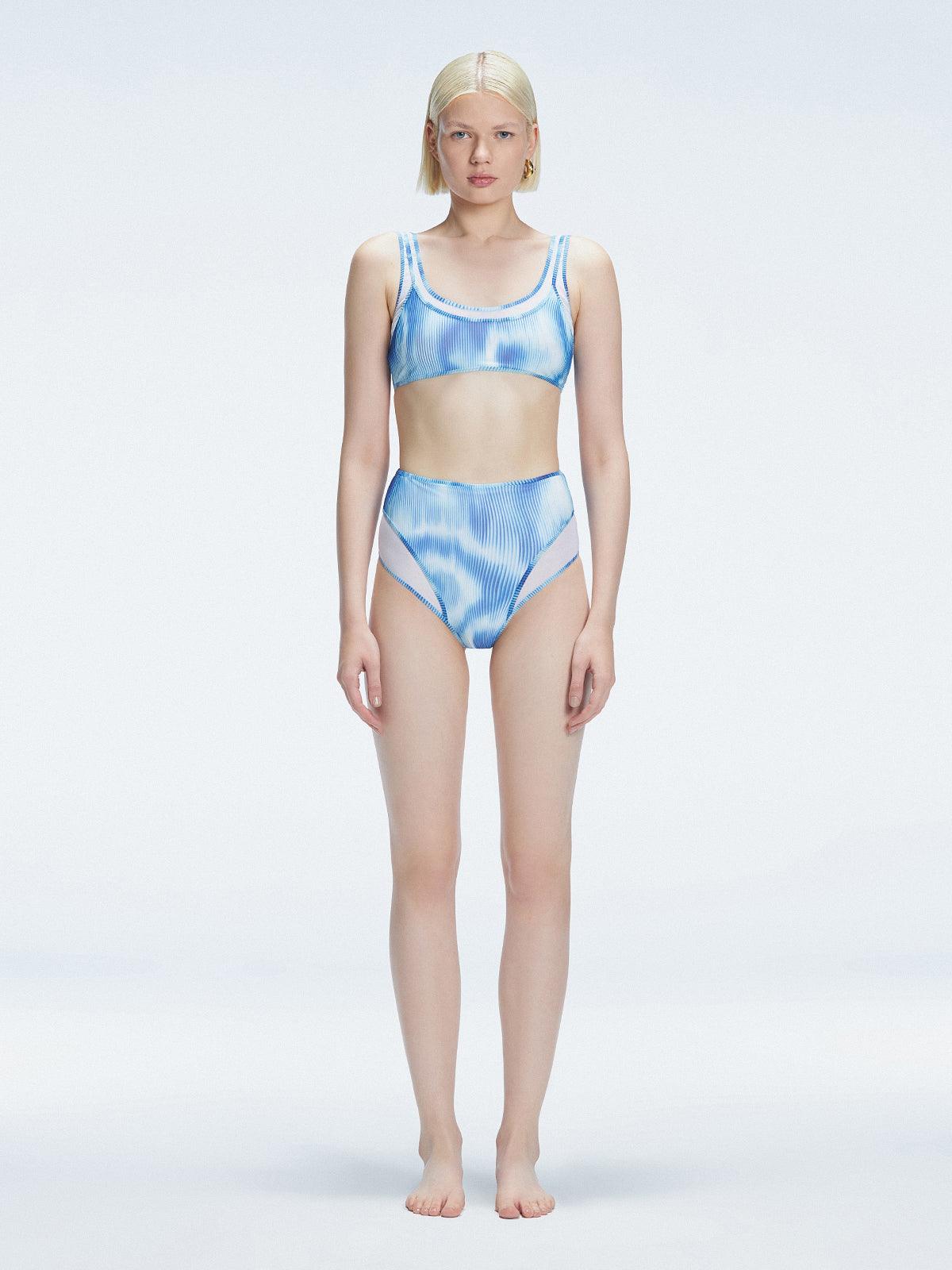 Front view of model wearing Rosalind Blue Optical Bikini Bottom with high-waisted design and two-layered tulle.
