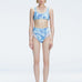 Front view of model wearing Rosalind Blue Optical Bikini Set with high-waisted design and two-layered tulle.
