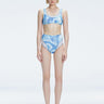 Front view of model wearing Rosalind Blue Optical Bikini Set with high-waisted design and two-layered tulle.
