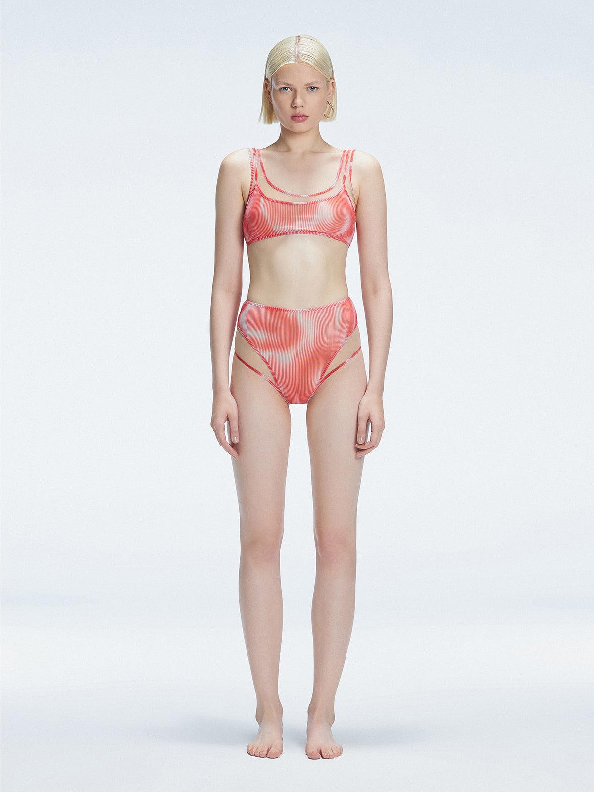 Front view of model wearing Rosalind Red Optical Bikini Bottom with high-waisted design and two-layered tulle.
