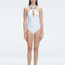 Front view of model wearing Rosamund White One Piece swimsuit with halter neck and gold sculpted hoop accessory.
