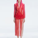 Model wearing the Rosie Red Sonar Dress, showcasing the hooded silhouette and vibrant red-pink color.