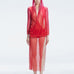 Model wearing the Rosie Red Sonar Dress, showcasing the hooded silhouette and vibrant red-pink color.