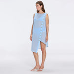 Solianne Blue Sheer Sleeveless Asymmetric Dress with Gold Button Detail | Moeva | Beachwear Dresses | Each week unveils new pieces—luxury swimwear, fluid resort silhouettes, and elevated summer-to-evening essentials designed to carry you from coastal escapes to city nights.