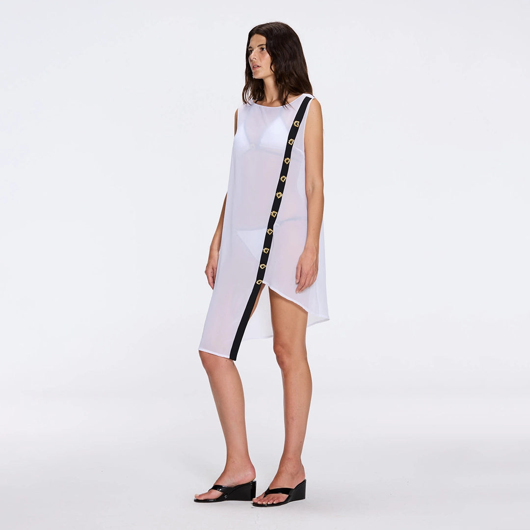 Solianne White Sheer Sleeveless Asymmetric Dress with Gold Button Detail | Moeva | Beachwear Dresses | Each week unveils new pieces—luxury swimwear, fluid resort silhouettes, and elevated summer-to-evening essentials designed to carry you from coastal escapes to city nights.