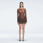 Sylvie Black Optical Long Sleeve Mini Dress | Moeva | Beachwear Dresses | Each week unveils new pieces—luxury swimwear, fluid resort silhouettes, and elevated summer-to-evening essentials designed to carry you from coastal escapes to city nights.