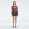 Sylvie Black Optical Long Sleeve Mini Dress | Moeva | Beachwear Dresses | Each week unveils new pieces—luxury swimwear, fluid resort silhouettes, and elevated summer-to-evening essentials designed to carry you from coastal escapes to city nights.