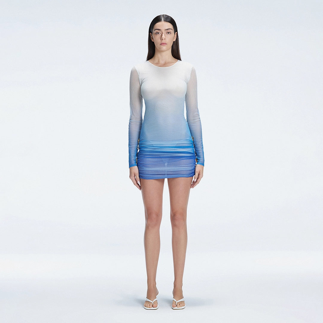 Sylvie Blue Optical Long Sleeve Mini Dress | Moeva | Beachwear Dresses | Each week unveils new pieces—luxury swimwear, fluid resort silhouettes, and elevated summer-to-evening essentials designed to carry you from coastal escapes to city nights.