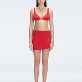 Front view of model wearing Siena Red Mini Skirt with buckle detail and two-layered design.
