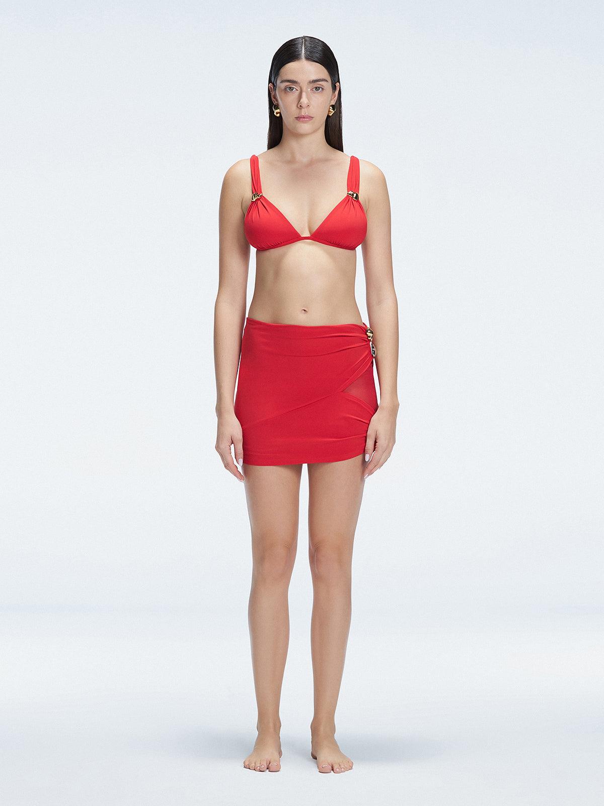 Front view of model wearing Siena Red Mini Skirt with buckle detail and two-layered design.
