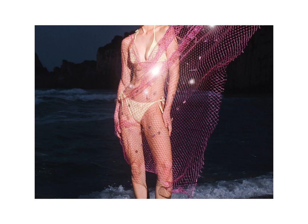 Close-up of the Sarita bikini’s textured fabric and bronze clasps, highlighting its premium Italian craftsmanship.
