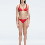 "Model wearing the Zella Red Bikini Bottom from the front view , featuring moderate coverage and a low waist fit."
