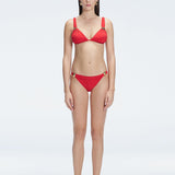 "Model wearing the Zella Red Bikini Bottom from the front view , featuring moderate coverage and a low waist fit."
