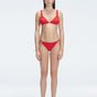 "Model wearing the Zella Red Bikini Bottom from the front view , featuring moderate coverage and a low waist fit."
