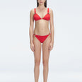 "Model wearing the Zella Red Bikini Set from the front view, featuring a personalized fit with removable padding."
