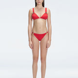 "Model wearing the Zella Red Bikini Set from the front view, featuring a personalized fit with removable padding."
