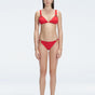 "Model wearing the Zella Red Bikini Set from the front view, featuring a personalized fit with removable padding."
