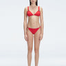 "Model wearing the Zella Red Bikini Set from the front view, featuring a personalized fit with removable padding."
