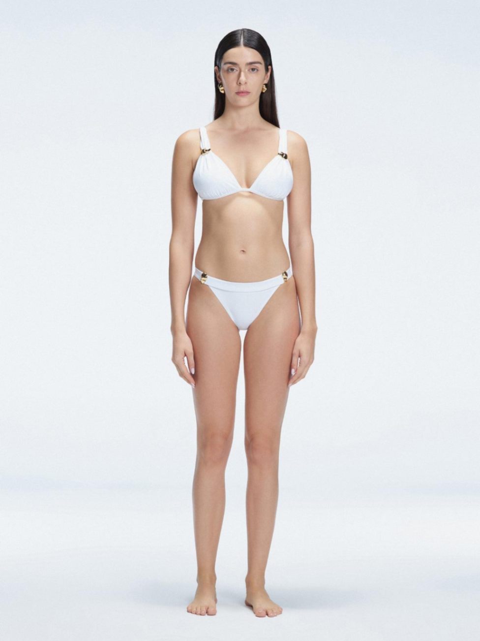 "Model wearing the Zella White Bikini Set from the front view , featuring moderate coverage and a low waist fit."
