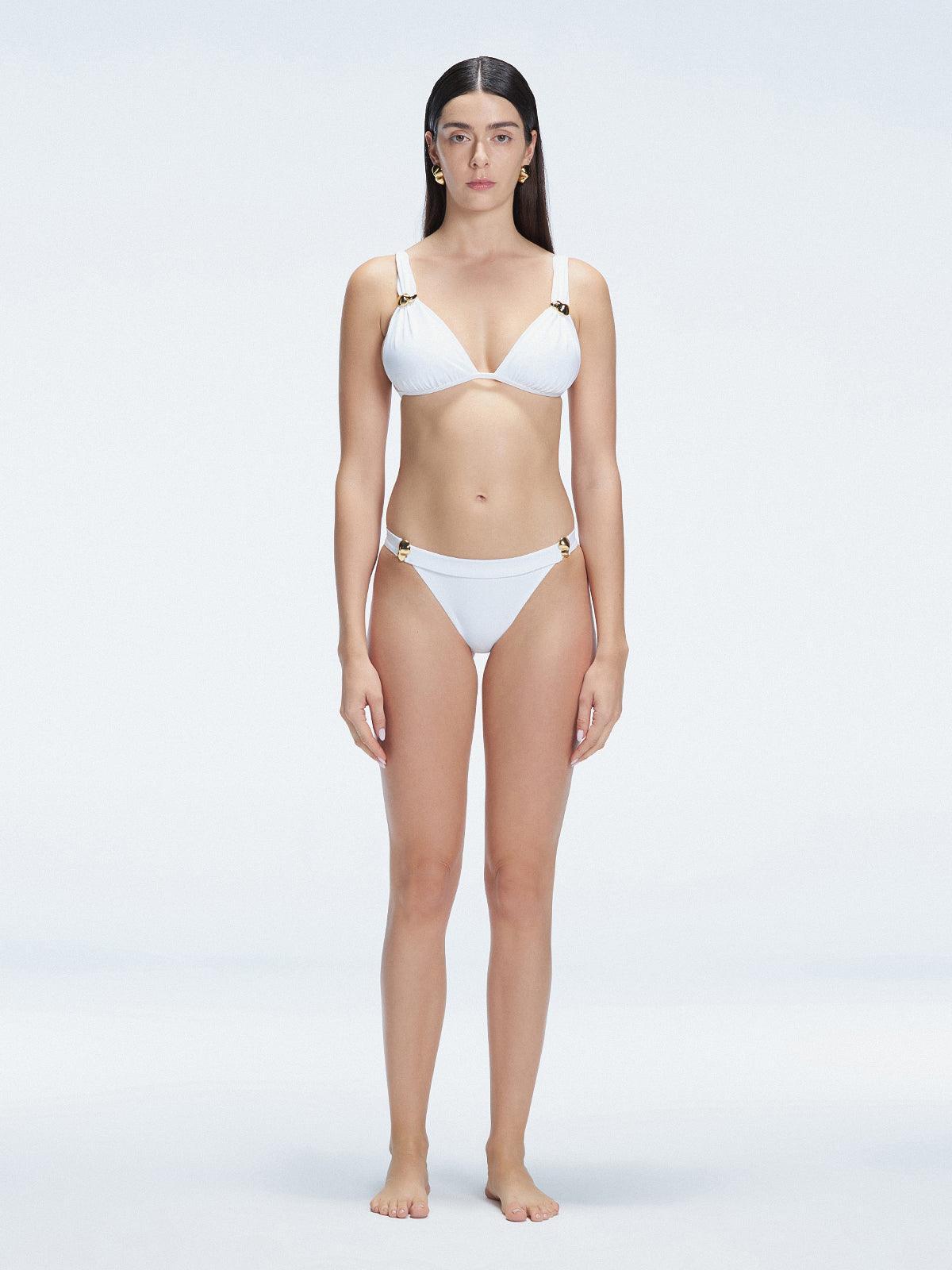 "Model wearing the Zella White Bikini Bottom from the front view , featuring moderate coverage and a low waist fit."
