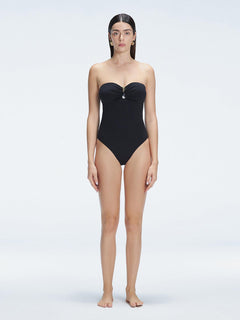 "Model wearing the Zephyrine Black Swimsuit from the front view, featuring removable straps and a chic buckle."
