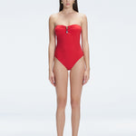 "Model wearing the Zephyrine Red Swimsuit from the front view, featuring removable straps and a chic buckle."
