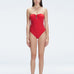 "Model wearing the Zephyrine Red Swimsuit from the front view, featuring removable straps and a chic buckle."
