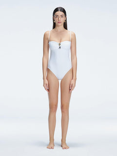 "Model wearing the Zephyrine White Swimsuit from the front view, featuring removable straps and a chic buckle."
