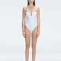 "Model wearing the Zephyrine White Swimsuit from the front view, featuring removable straps and a chic buckle."
