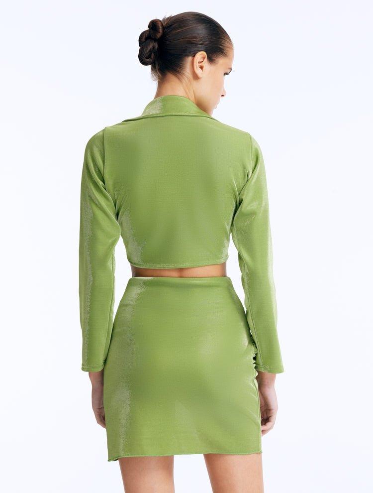 Back view  of Greta Green Shirt’s long sleeves and tie-front detail styled with Indigo Skirt.
