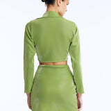 Back view  of Greta Green Shirt’s long sleeves and tie-front detail styled with Indigo Skirt.
