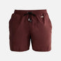  A collage of the Louis Bordeaux mid-thigh length men's swim shorts from various angles. The front view emphasizes the elastic waistband, drawstring with black nickel stoppers, and Moeva patch. The back view showcases the rich bordeaux color and sleek design. The side view highlights the two open side pockets and tailored fit, hinting at the fabric's lightness and quick-dry properties. A close-up focuses on the fabric texture, drawstring details, and craftsmanship. The collage collectively illustrates the s