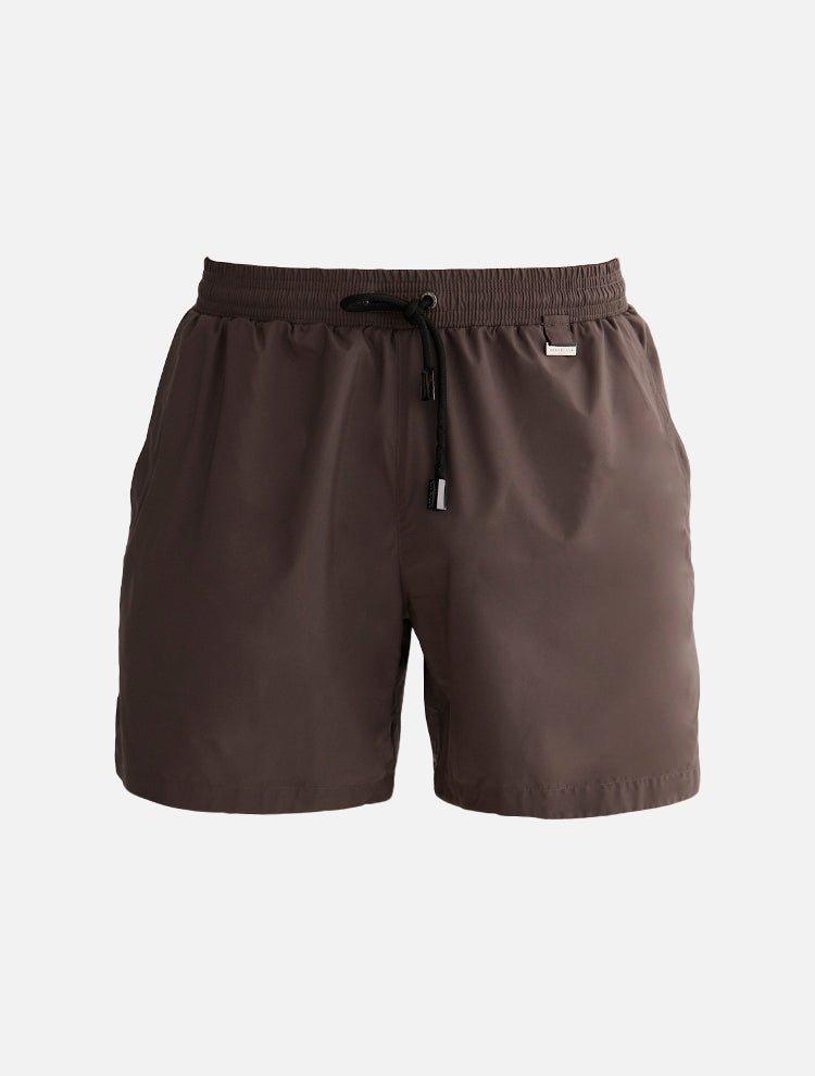 Decoupage image of Louis Brown ultralight men's swim shorts by Moeva, highlighting various angles and details, showcasing the sleek design, minimalist style, and lightweight fabric, ideal for beach or pool wear.