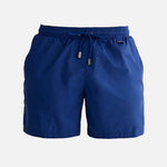 "Decoupage image of Louis dark blue mid-thigh length men's swim shorts by Moeva, showcasing multiple angles and features. Highlighting the ultra-light, quick-dry fabric, elastic waistband, drawstrings with black nickel stoppers, and Moeva patch. Ideal for creating an elegant beachside look."