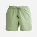 "Decoupage image of Louis mint green mid-thigh length men's swim shorts by Moeva, showcasing multiple angles and details. Highlighting the ultra-light, quick-dry fabric, elastic waistband, drawstrings with black nickel stoppers, Moeva patch, and two open pockets. Perfect for creating a stylish and comfortable beachside look."